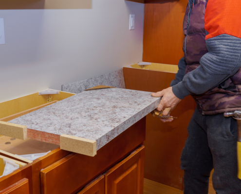 Contractor installing new laminate kitchen counter top